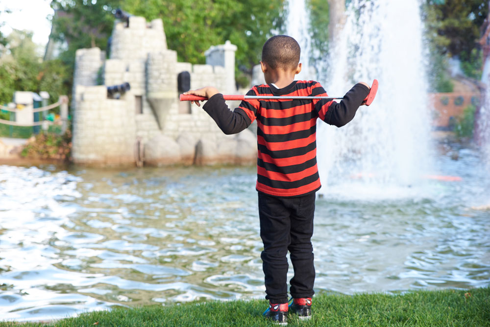 young boy golfing - club over shoulders