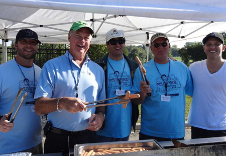 four men enjoying catered group meal